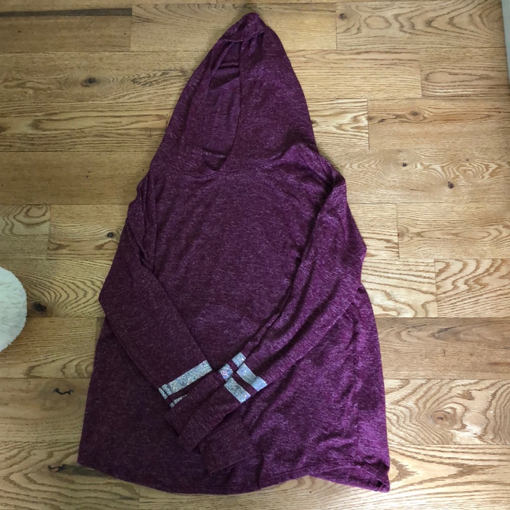 Purple sweater with glitter stripes.
